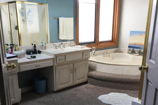 This before shot of one of our ReBath Omaha bathroom remodel projects shows how ugly shiny brass and chrome can be. Add in a dated corner bathtub, outdated bathroom vanity, and carpet floors and you have a disaster begging for our free bathroom design solutions and premium custom products!