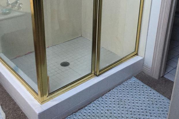 Shiny brass is the worst...or maybe its the water damage caused by porous grout that make these tiles look discolored and moldy...or maybe it's the uneasy feeling you get from having carpet in the bathroom. At any rate, this outdated 90's palace is a hot mess waiting for a ReBath Omaha bathroom remodel with shower update.