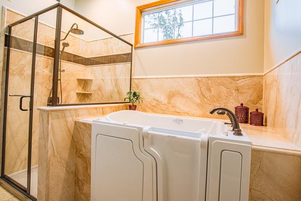 Sometimes you feel like a soak and sometimes you don't. Having the room to do a full ada bathroom remodel can afford you the luxury of a walk-in tub and a low-profile shower upgrade. For this ReBath Omaha bathroom renovation, the french mocha marble surround envelopes this jetted walk-in tub and luxury shower in serenity and style with it's timeless traditional bathroom design.