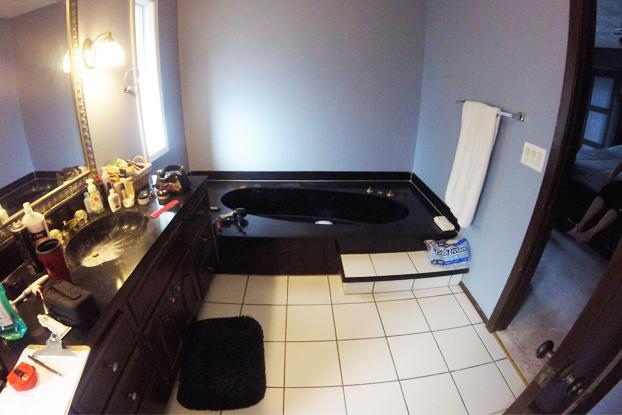Is this a Weekend at Bernie's flashback? No, it's an outdated black and purple bathroom in Omaha, Nebraska had a complete ReBath bathroom remodel to a contemporary bathroom design of this decade!