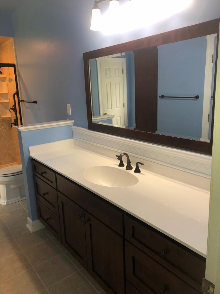 This vanity and mirror collection is from Bertch. The style is Osage in birch wood and color of Brindle. Oil rubbed bronze Moen fixtures and accessories compliment this color choice.