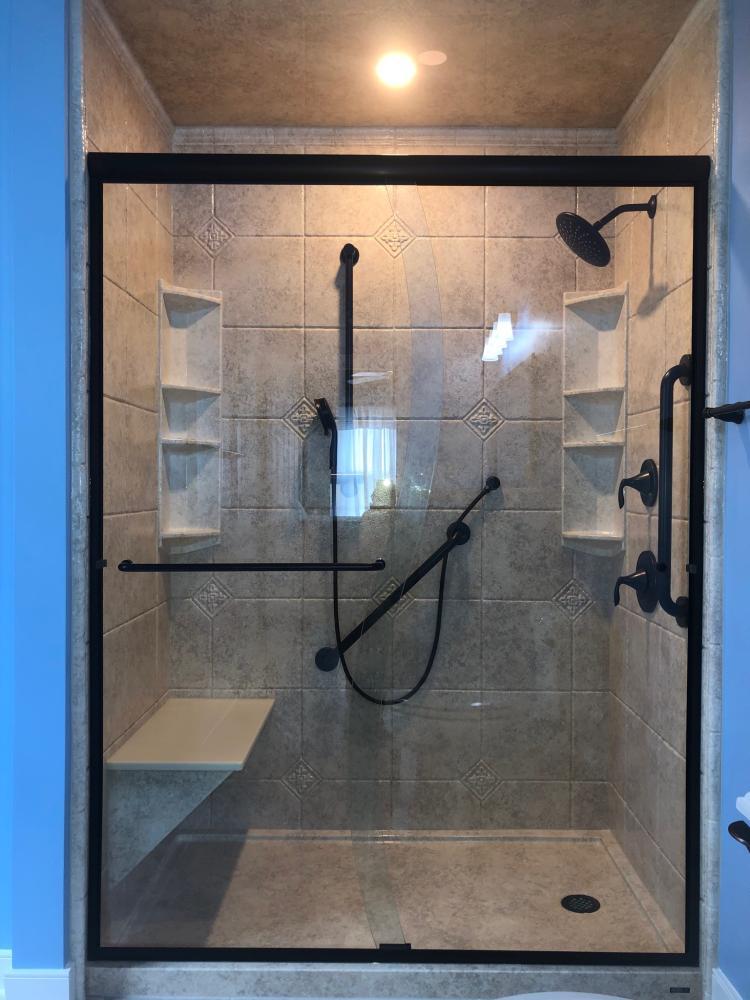 Sonoran Granite Acrylic Durabath in a Tuscan design cover the walls. The matching base and ceiling tie it all together. Handheld accessory is placed close to seat for convenience.