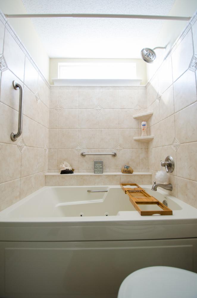 Brand new wall surround, shower head, safety handlebars, shower shelves, and jet tub