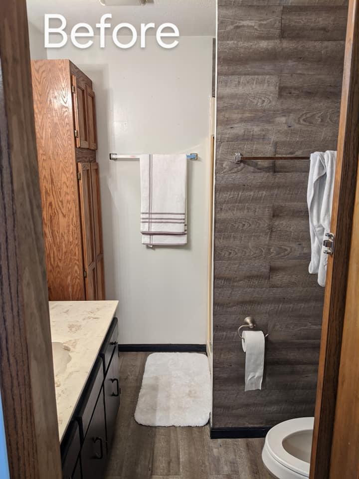 This was a before shot of a super dated bathroom which consisted of a small fiberglass shower and dated oak cabinets.