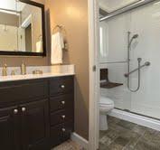 The remodeled ReBath bathroom included a new, higher vanity and counter top, and new lighting and mirror. The flooring and fixtures were also updated with beautiful new materials. The updated shower included a fold down seat, grab bars and a hand held shower head, and a new shower door operates much better than the previous shower curtain. The new Durabath shower walls mean easier maintenance with no grout lines!