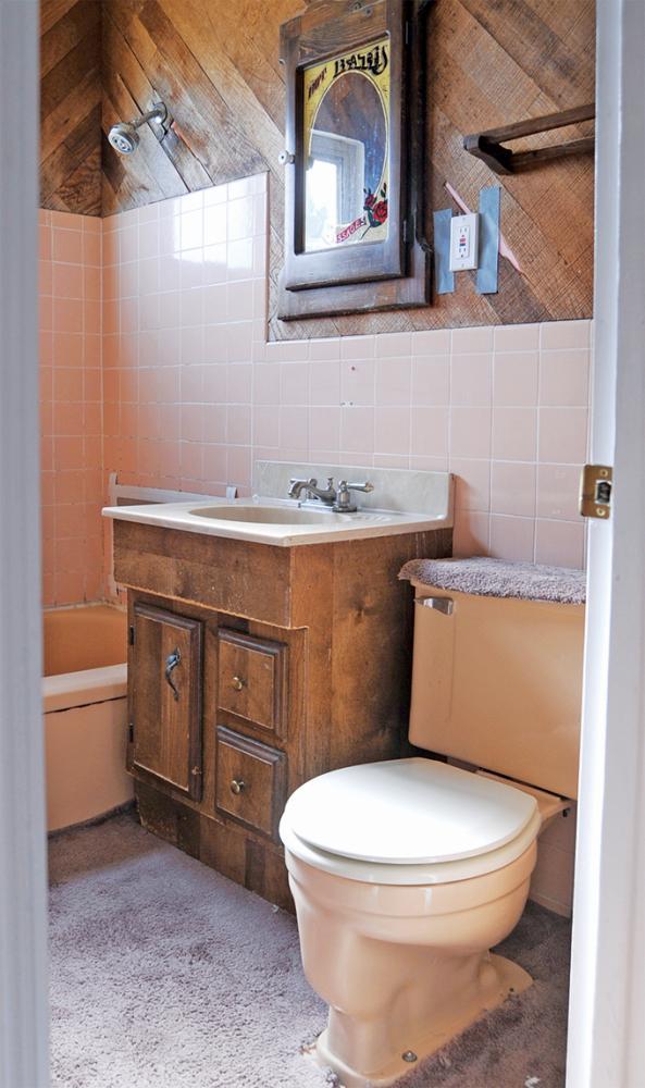 This small outdated bathroom was in need of remodel. ReBath tore it down to the studs, removing the 50's pink tile and wood on the wall. The pink fixtures, outdated vanity and carpet that was on the floor were also removed.