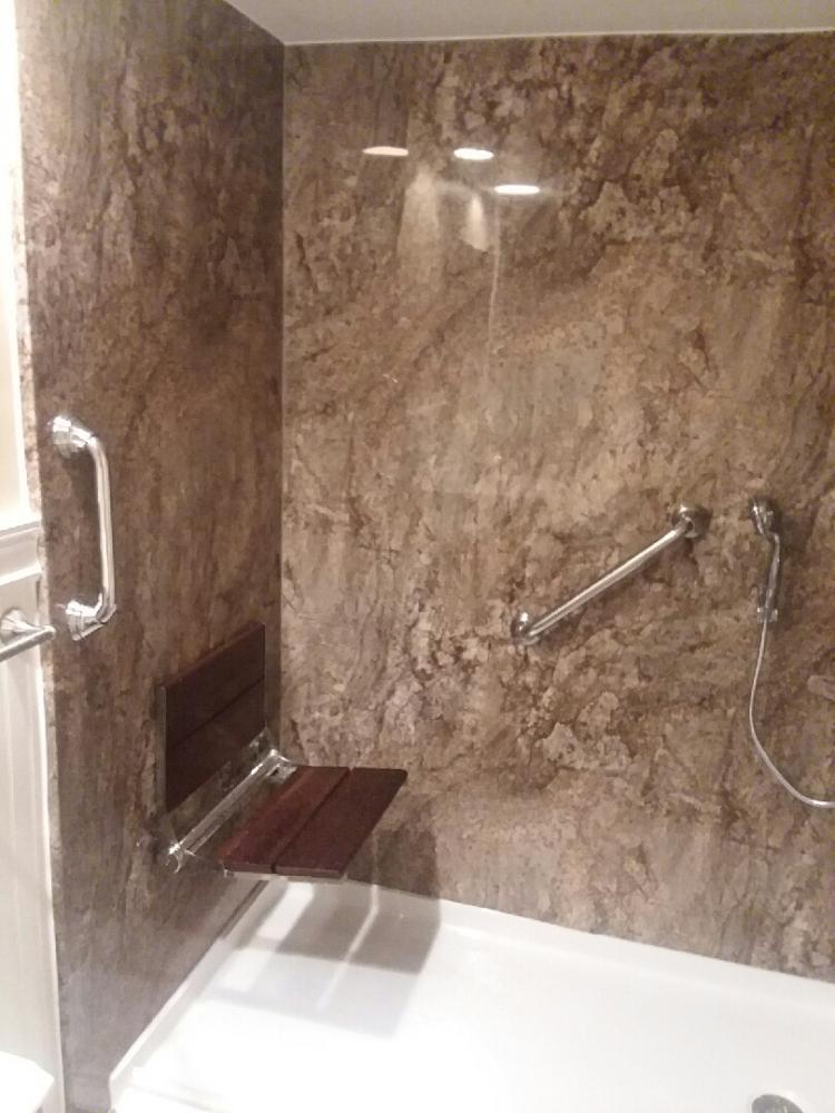 Tub to Shower conversion with barrier free shower pan, seating, and grab bars.