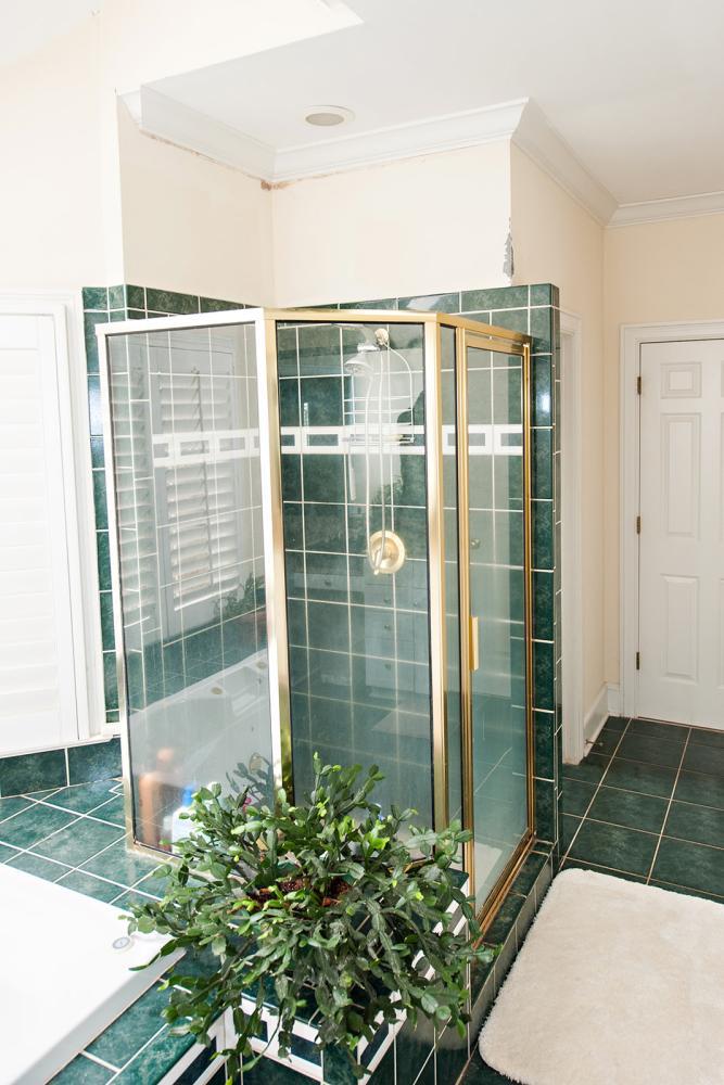 Dated tile shower and gold metal shower frame
