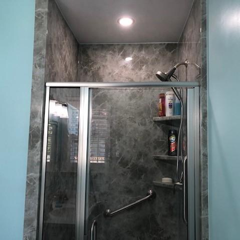 Re-Bath Grey Emperador Walls with an Arizona Door and Fixed Panel. Moen Magnetix Shower