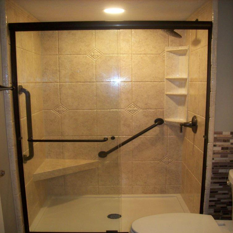DuraBath acrylic wall surround makes this shower easy to clean. Oil Rubbed Bronze fixtures. Corner seat with clear glass sliding door makes this shower feel spacious.