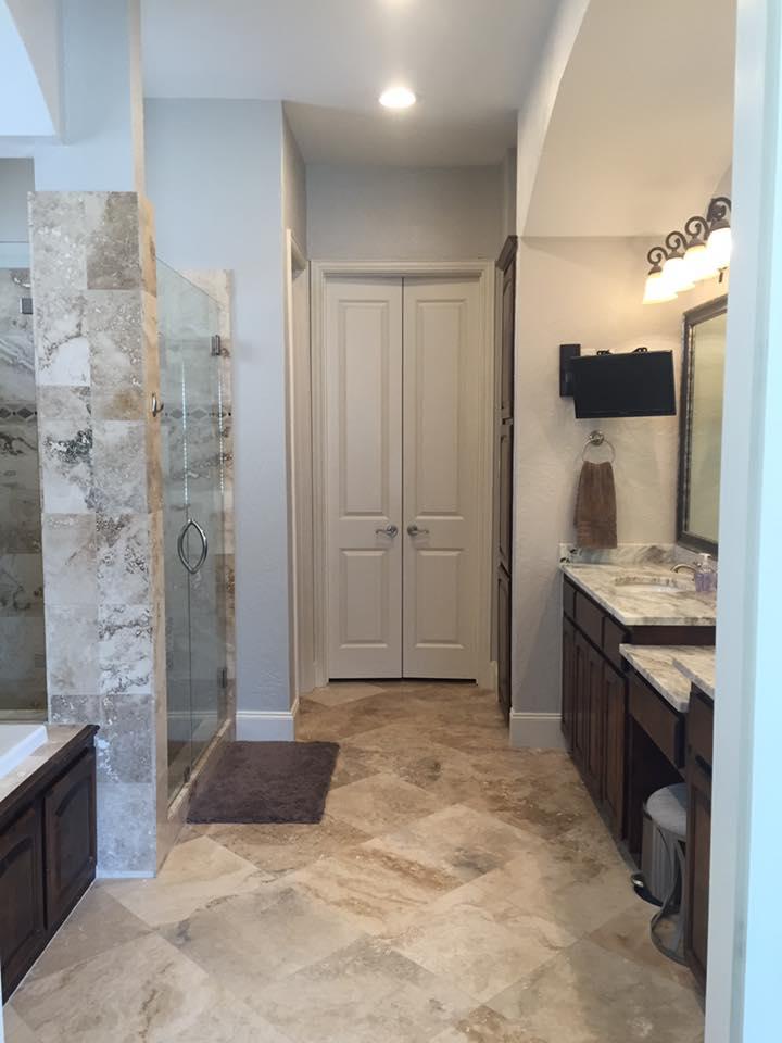 Travertine bathroom with dual vanity