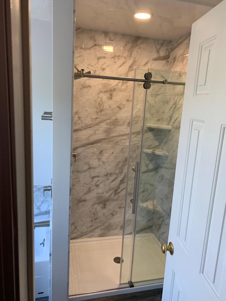 After Re-Bath Fairfield County, CT custom tile pattern shower with dreamline barn-style glass sliding door renovation